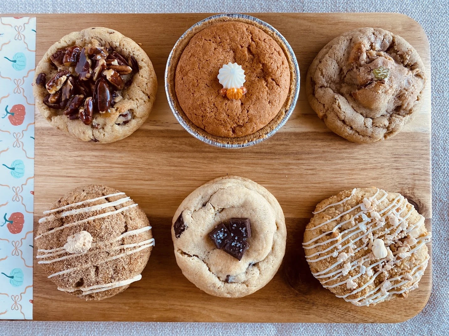 All six November cookies on a wooden board